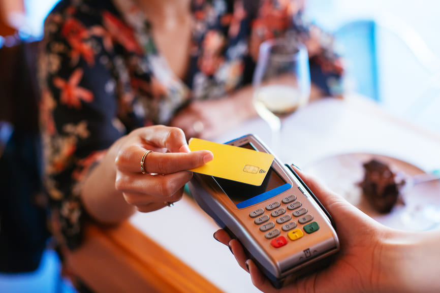 Close-up of a contactless credit card payment at a restaurant