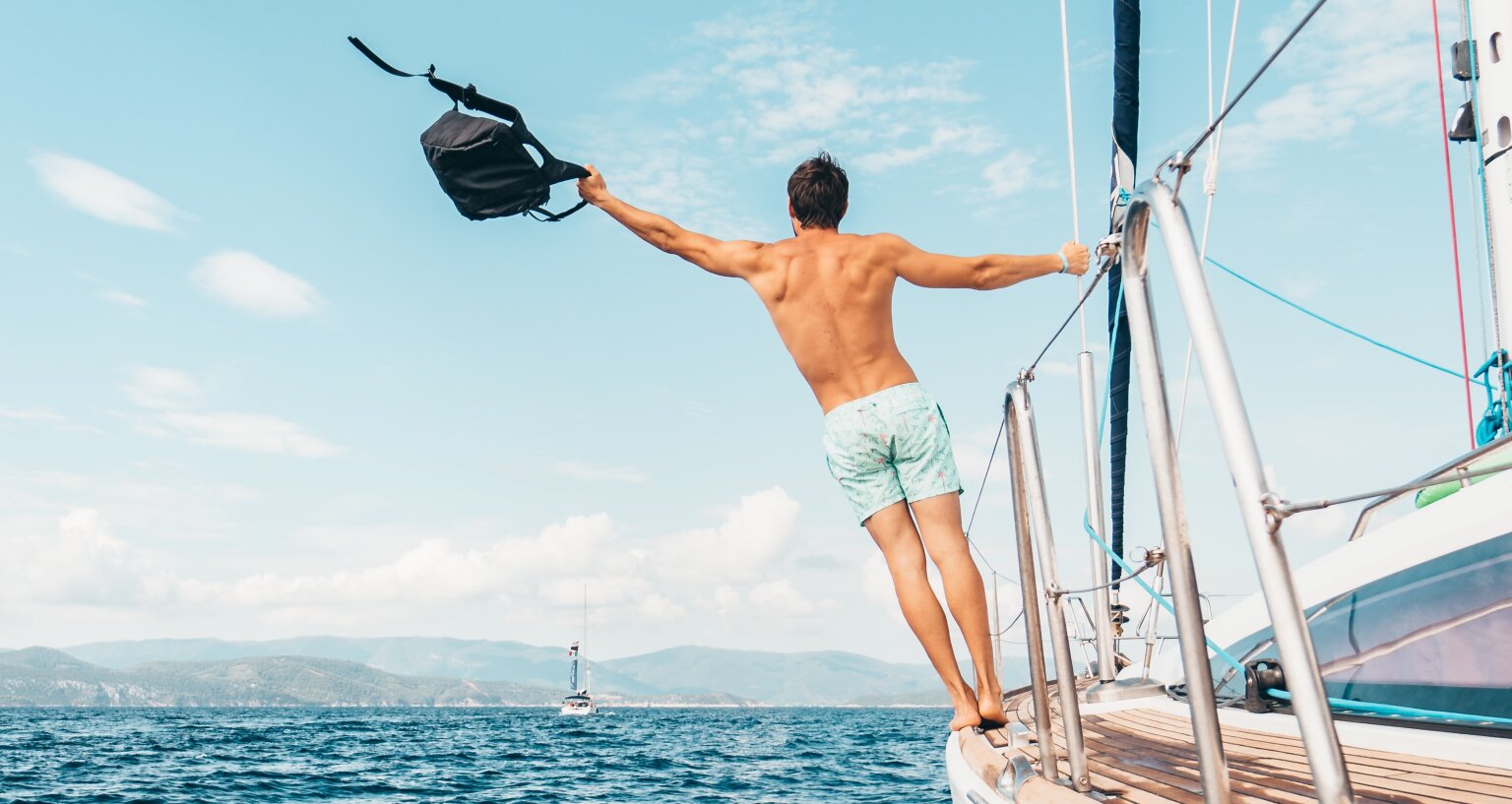 Man with a backpack on a boat