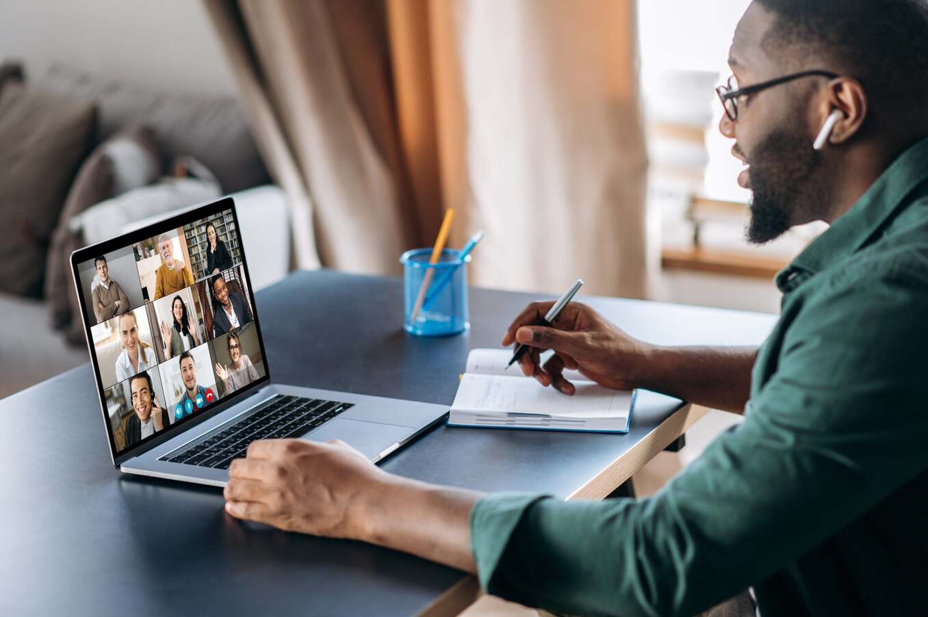 Man attending a virtual meeting on his laptop