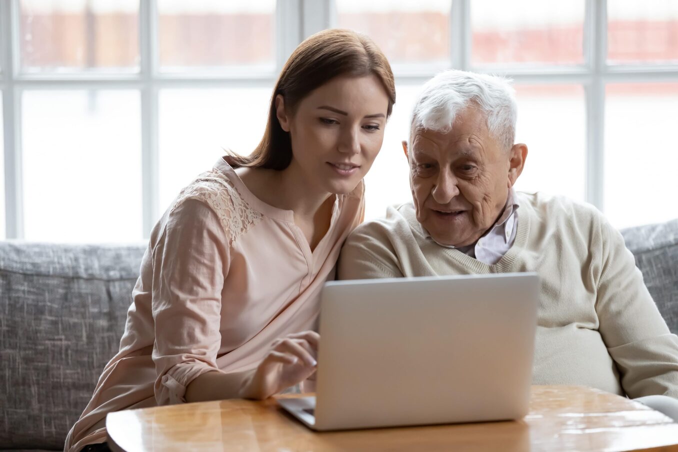 Young woman and grandfather researching 401(k) vs IRA