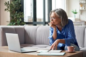 Senior woman reviewing financial documents at home