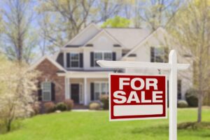 House with a "for sale" sign in front