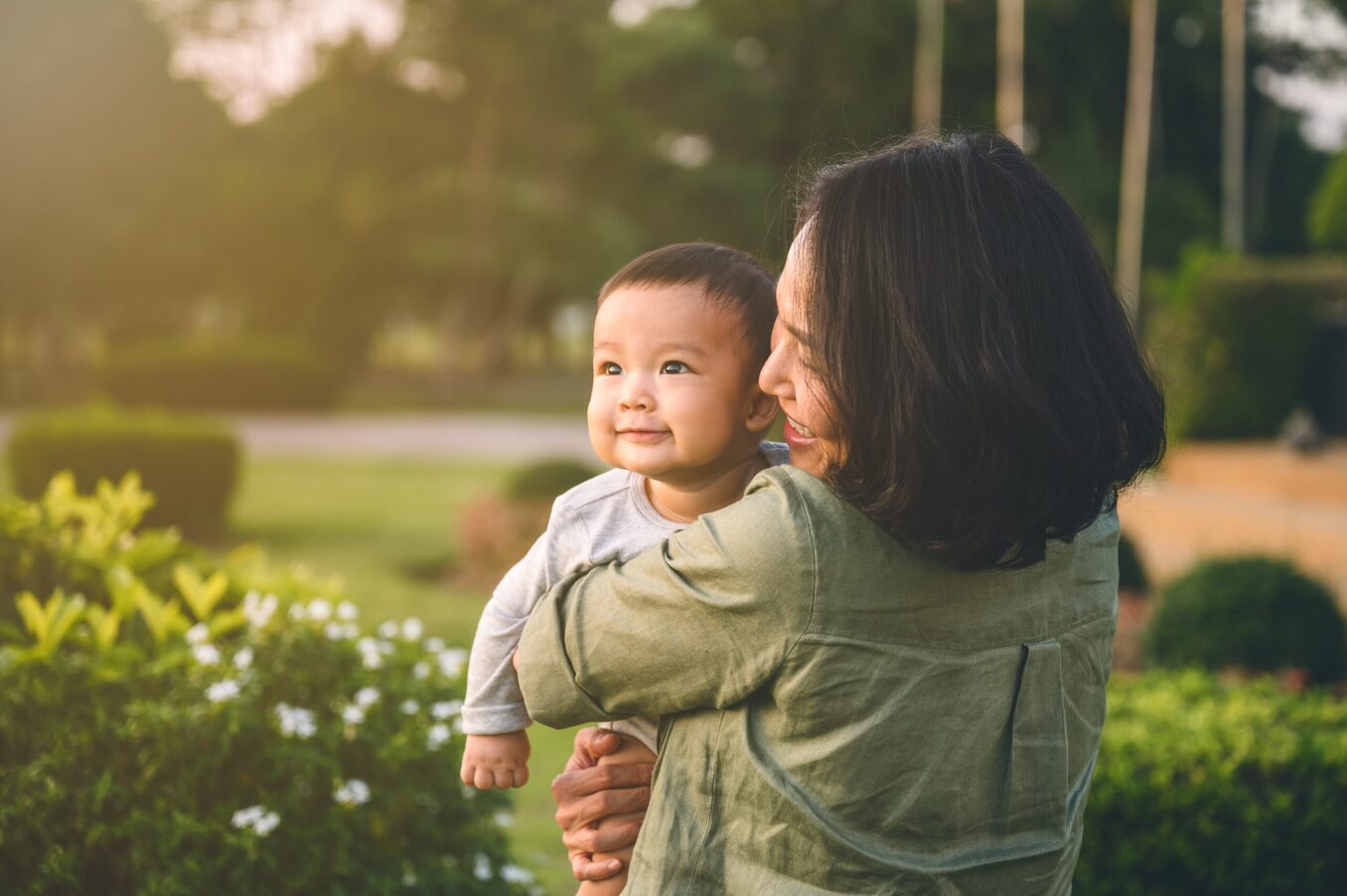 Young mother holding a baby in nature