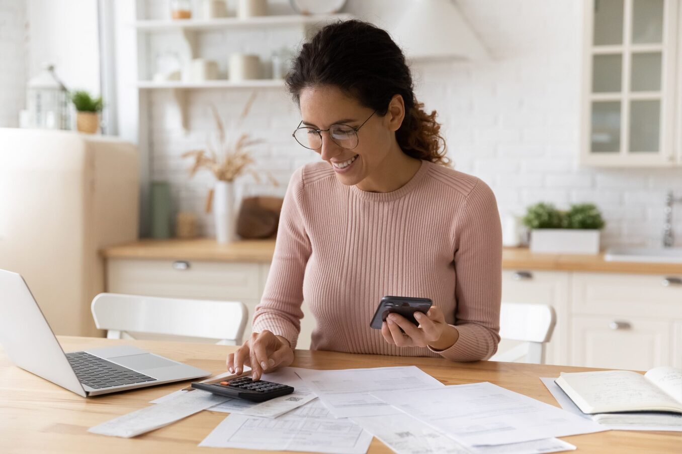 Woman doing calculations and smiling