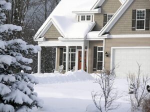 Close-up of a house front porch covered in snow