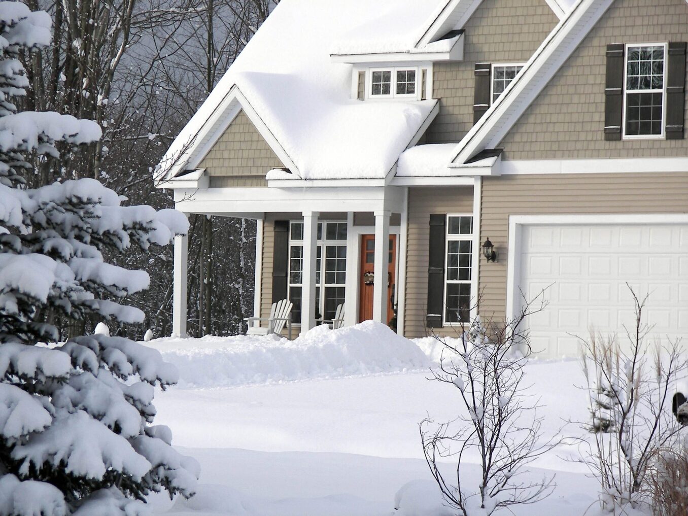 Close-up of a house front porch covered in snow