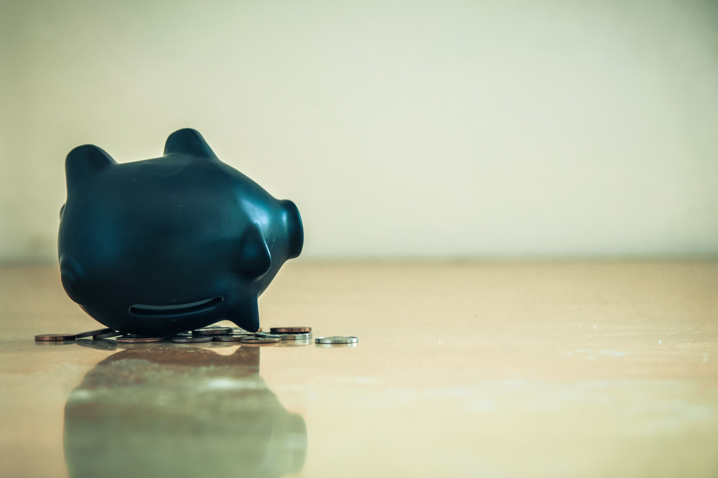 Piggy,Bank,Upside,Down,And,Coins.,Financial,Crisis,Concept.