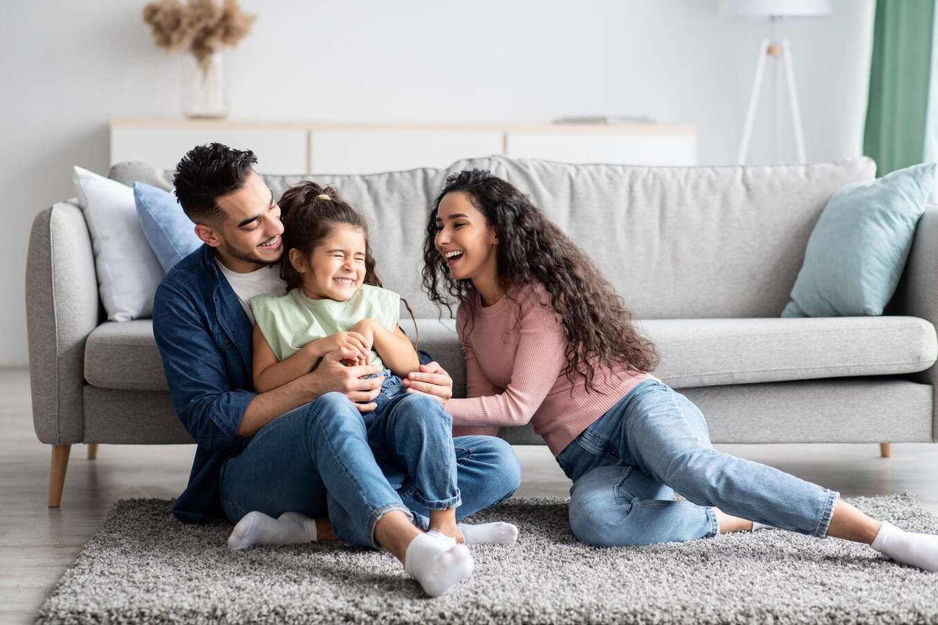 Middle Eastern Parents Having Fun With Their Little Daughter At Home