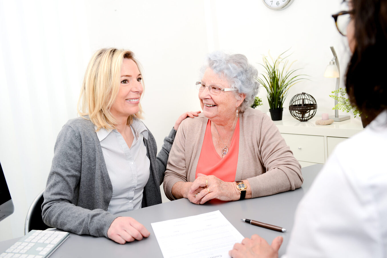 elderly senior woman with daughter signature legacy inheritance heritage testament document in a lawyer notary office