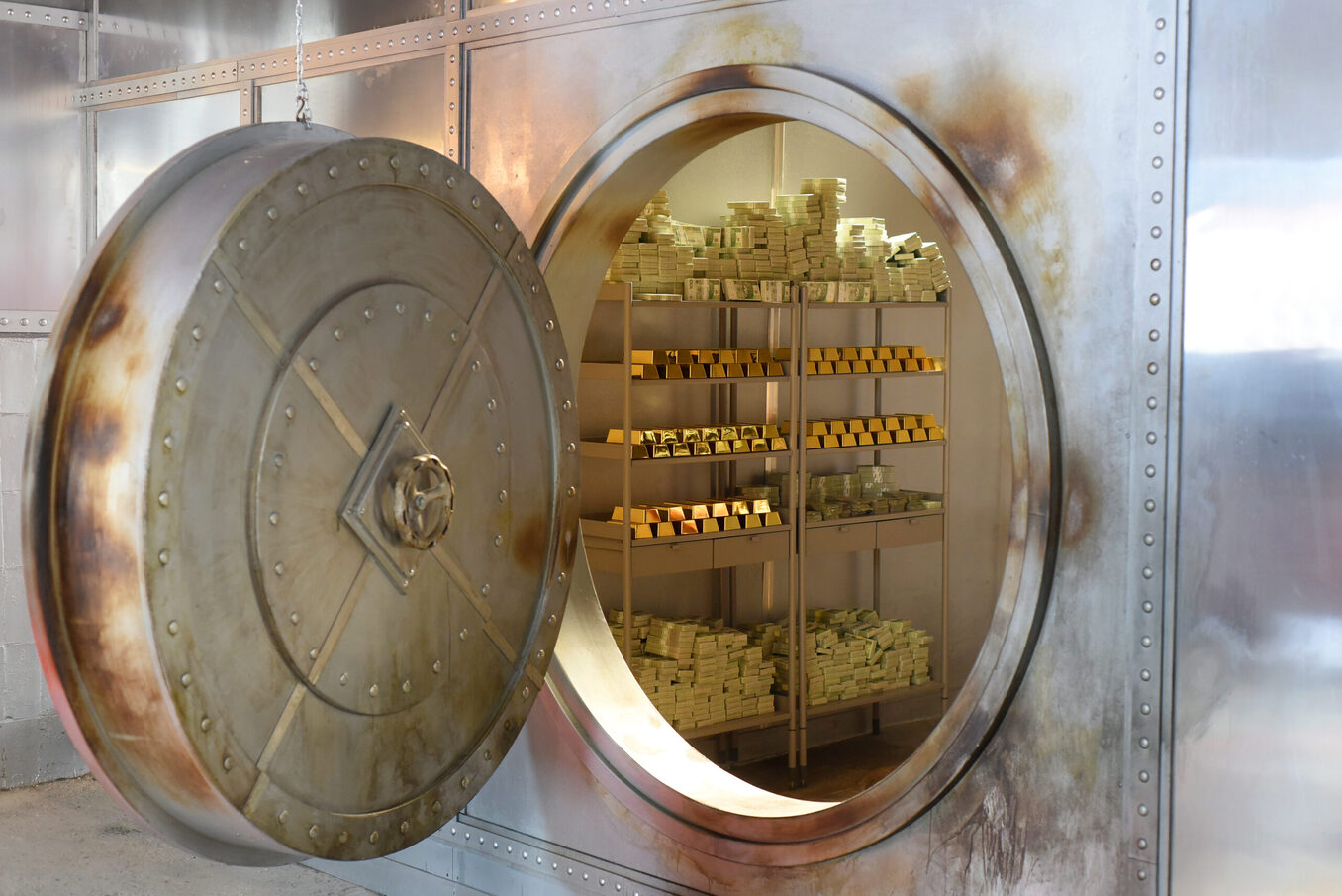 An open safe with gold and banknotes