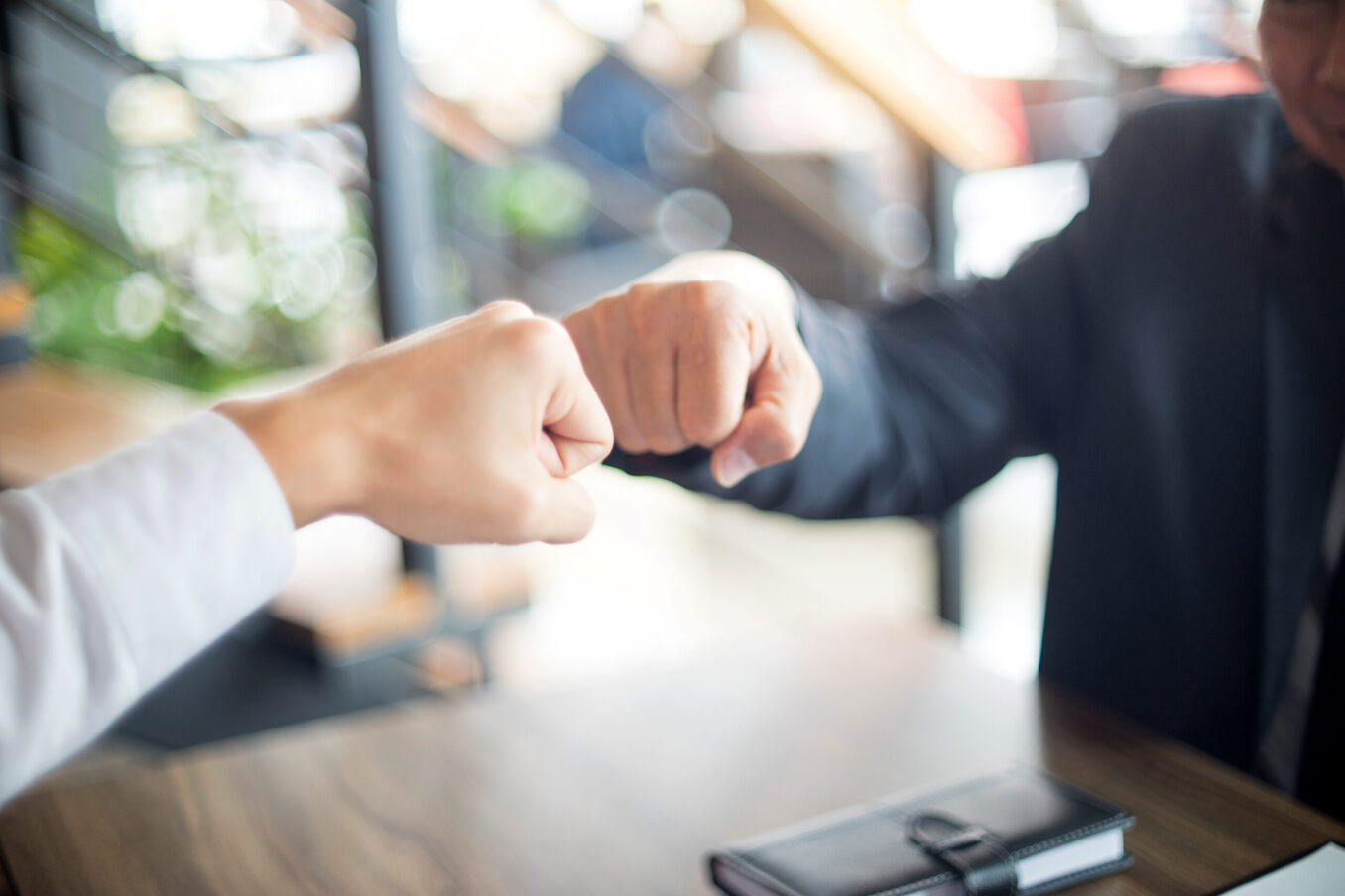 two business man use hand to fist bump for success teamwork corporate