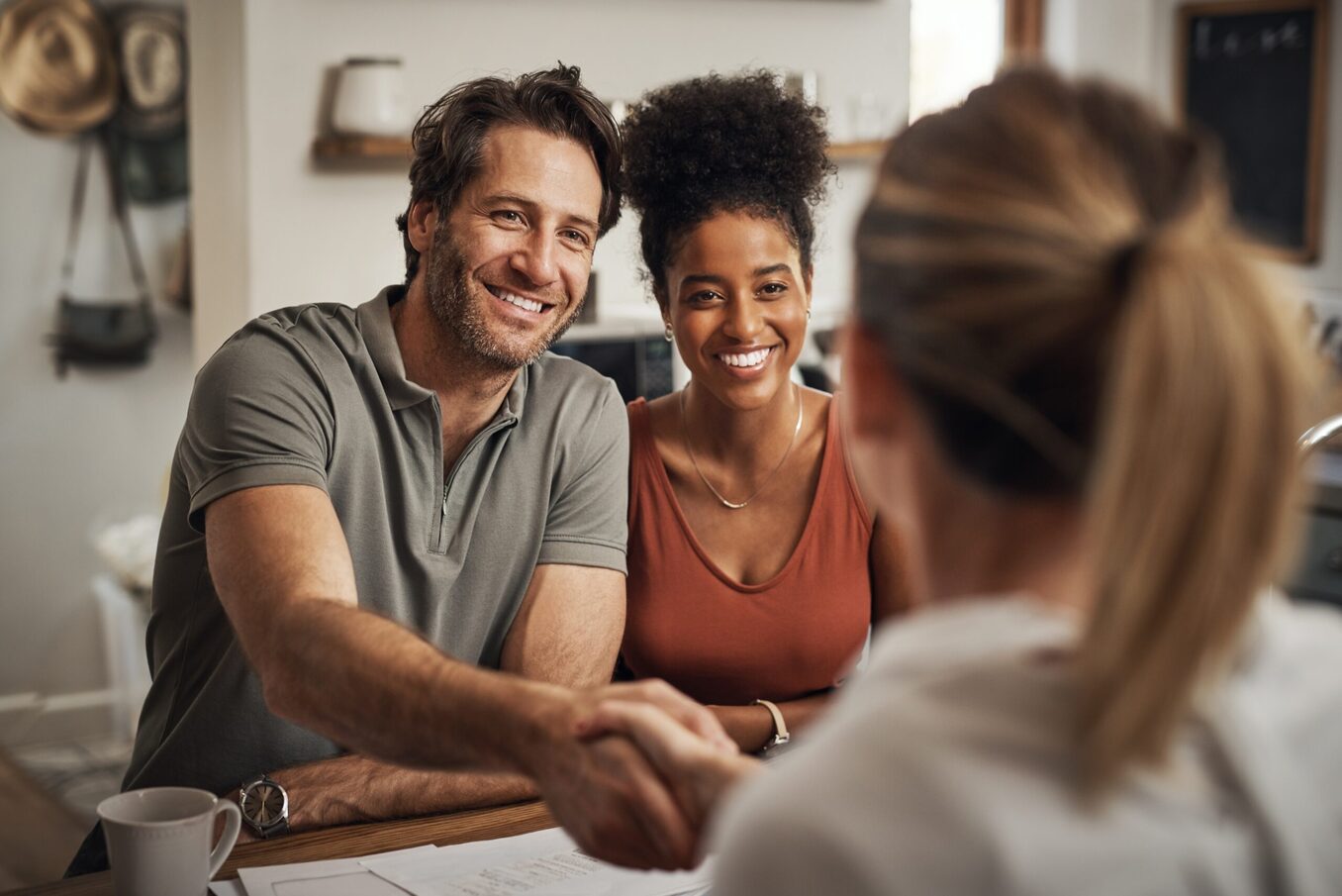Young couple handshaking with advisor