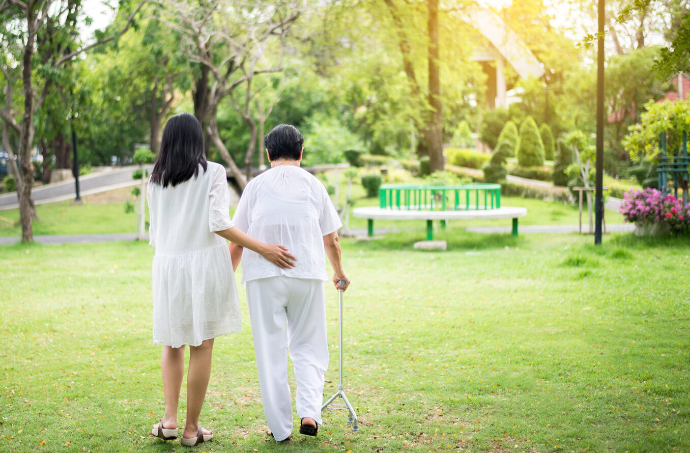 Elderly Asian women standing and walking in garden