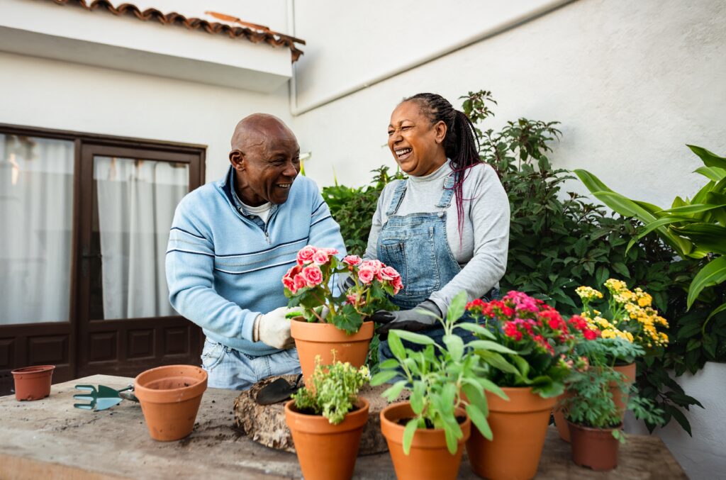 Couple gardening and enjoying a life free from financial worries.