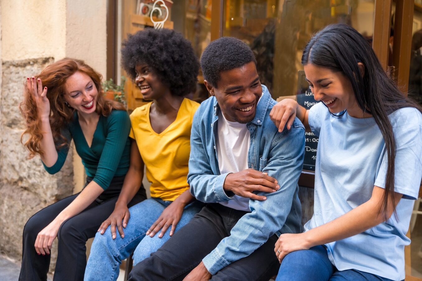 Multi-ethnic friends in a coffee shop sitting in the doorway