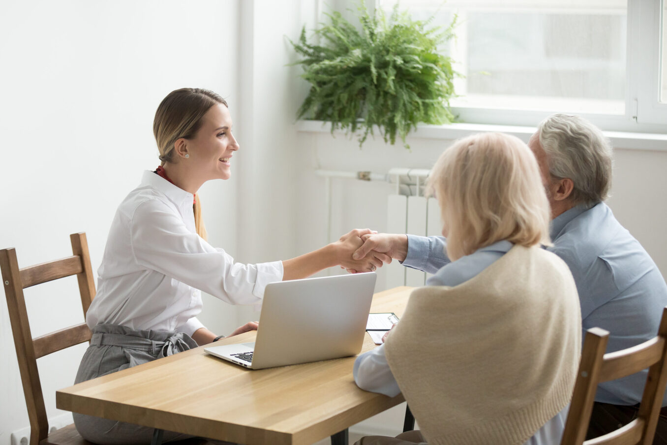 Smiling female lawyer real estate agent or financial advisor handshaking