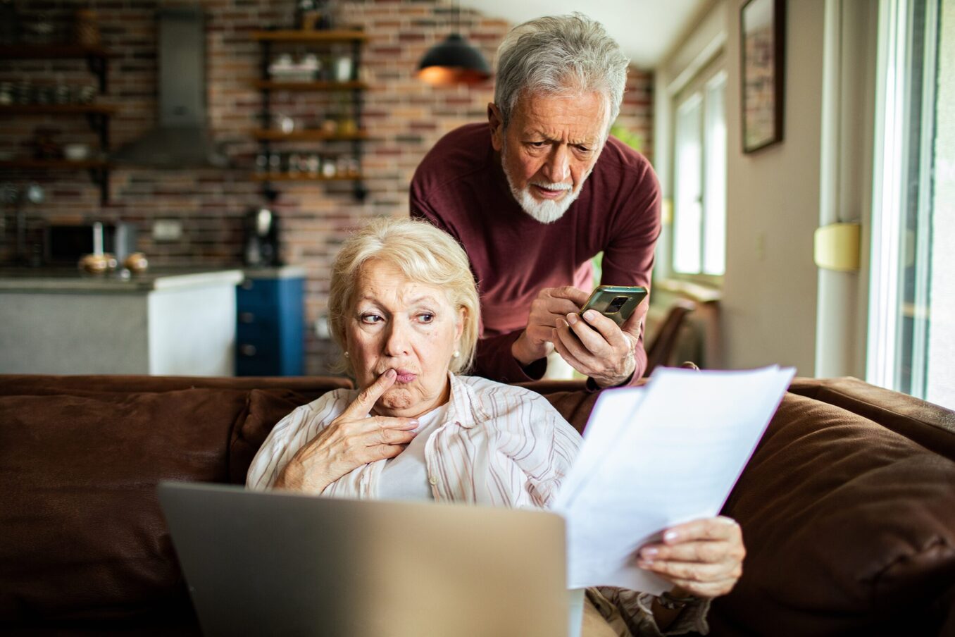Close up of a senior couple going over their bills