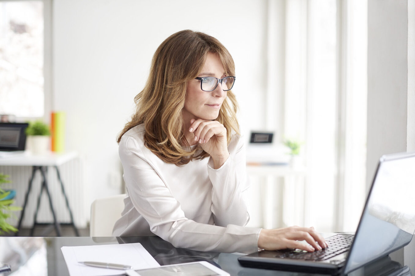 Woman working on laptop in a professional setting