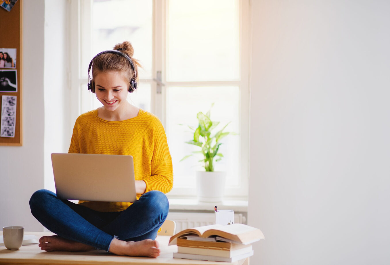 Woman working on laptop and listening to music