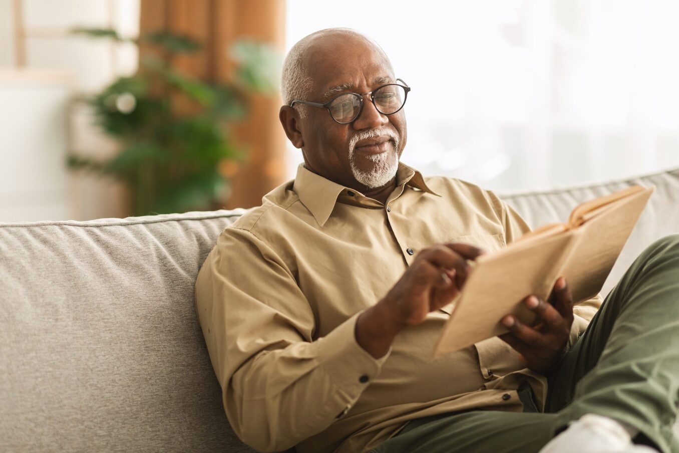 Man reading a book in a home environment