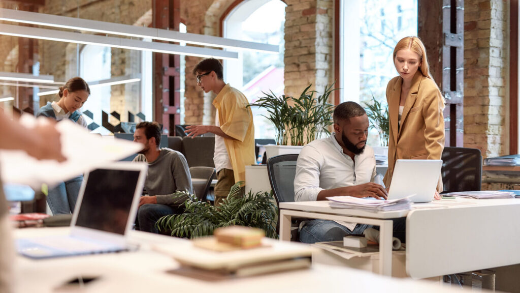Group of multiracial business people working together in the creative co-working space. Team building concept. Office life