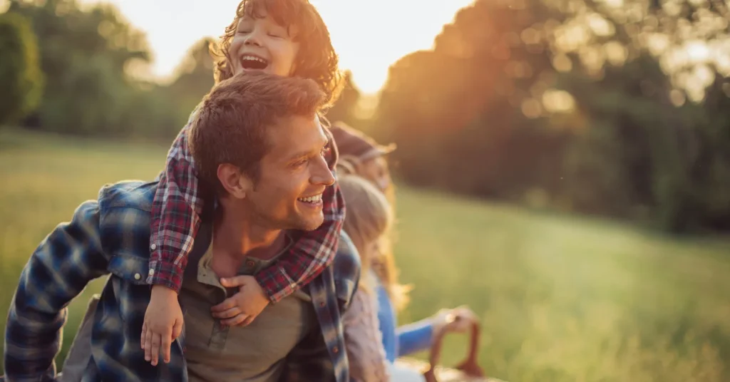 Father carrying son on his shoulders