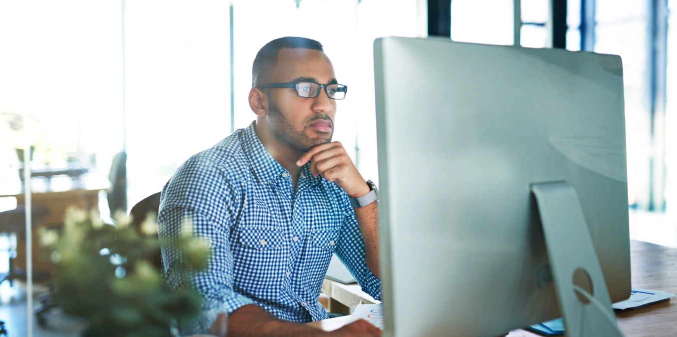 Business man, thinking and computer at desk in office