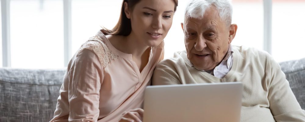 young woman and grandfather researching 401(k) vs IRA