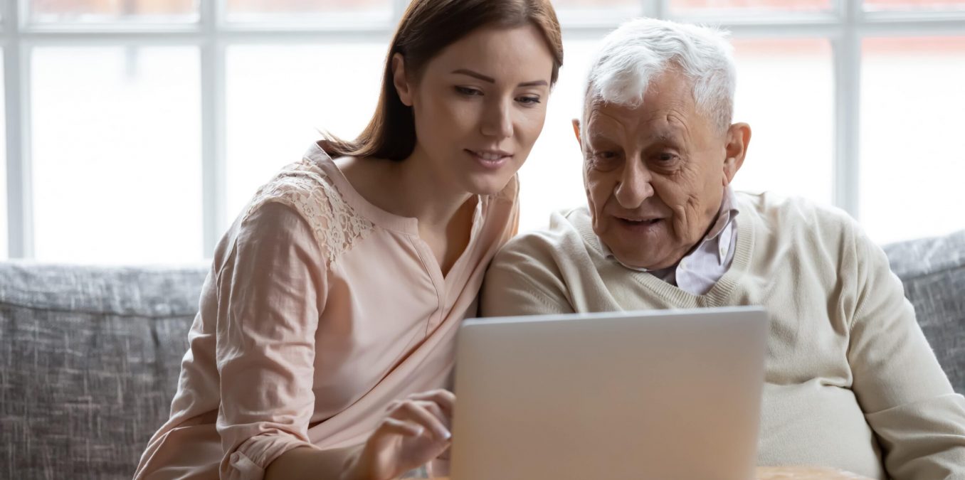 young woman and grandfather researching 401(k) vs IRA