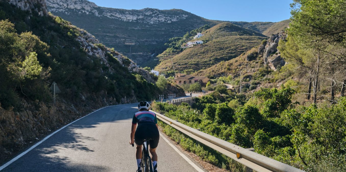 A,Woman,Cyclist,Riding,On,Mountain,Road.,Cyclist,On,The