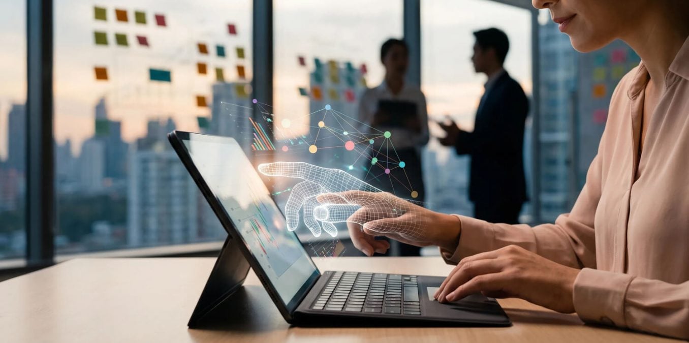 A financial advisor wearing professional attire sits at a desk in a modern office. She points at a tablet displaying a variety of stock market graphs and data. A glowing, semi-transparent wireframe image of a human hand mimics her movement on the tablet screen, symbolizing the collaboration between human judgment and artificial intelligence in financial analysis.
