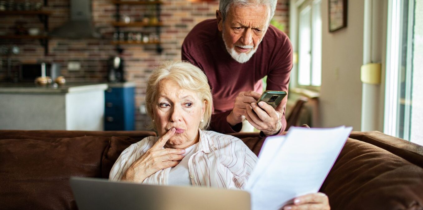 Close up of a senior couple going over their bills