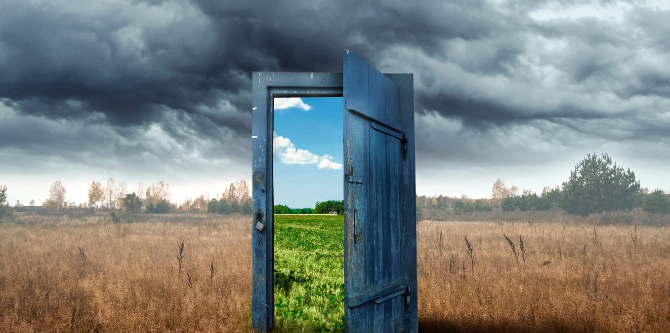 Creative background. Old wooden door, blue color, in the box. Transition to a different climate. The concept of climate change, portal, magic. Copy space.