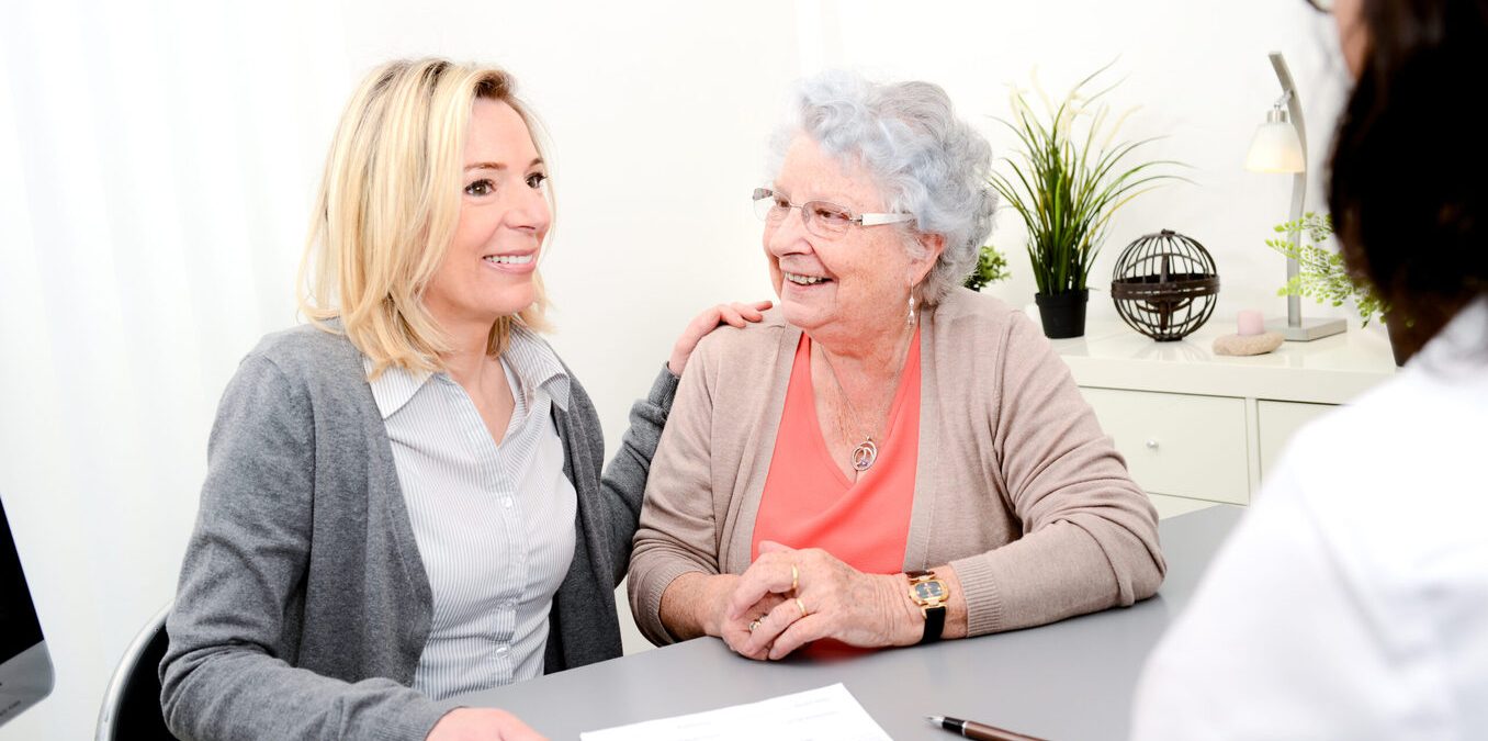 elderly senior woman with daughter signature legacy inheritance heritage testament document in a lawyer notary office