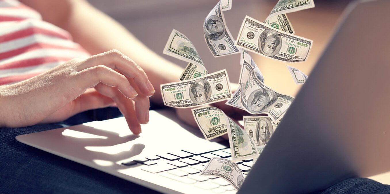 Financial concept make money on the Internet. Woman sitting on couch with laptop open