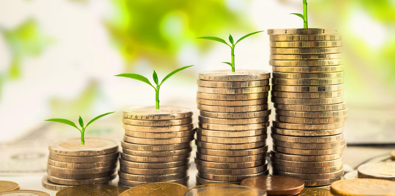 step of golden coins stacks on table with tree growing on top, nature background, money, saving and investment concept
