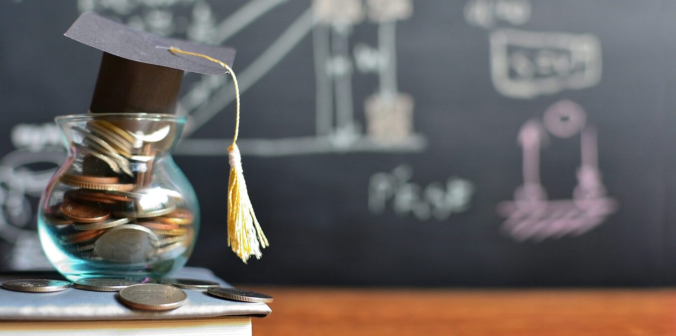 Hat graduation model on coins saving for concept investment education and scholarships
