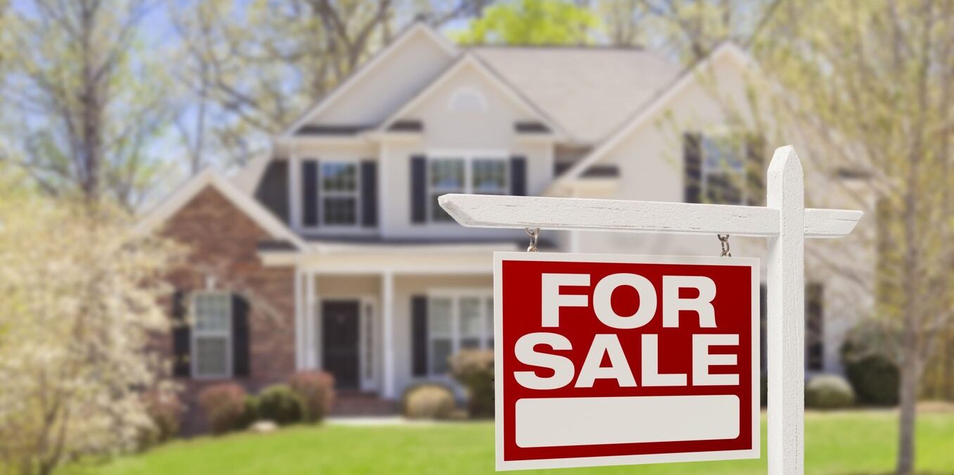 House with a "for sale" sign in front