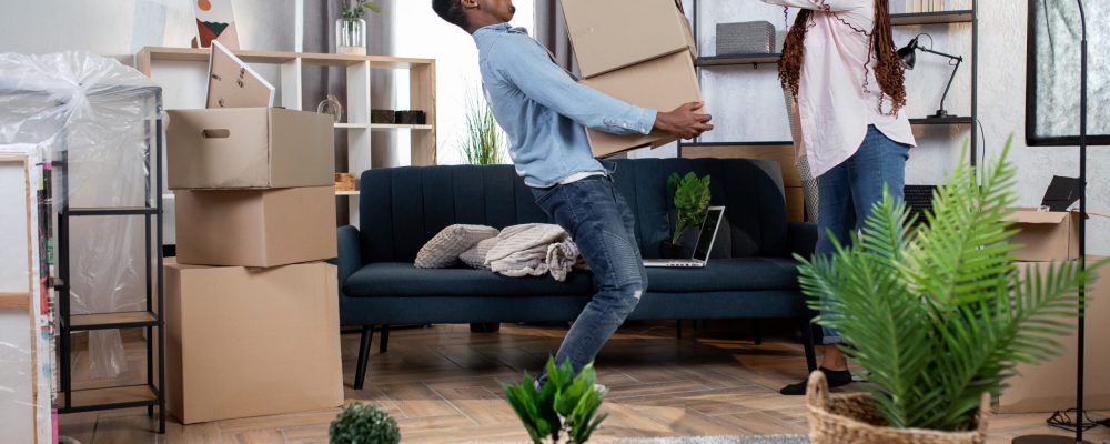 Young,African,Couple,In,Casual,Clothes,Packing,Boxes,For,Moving