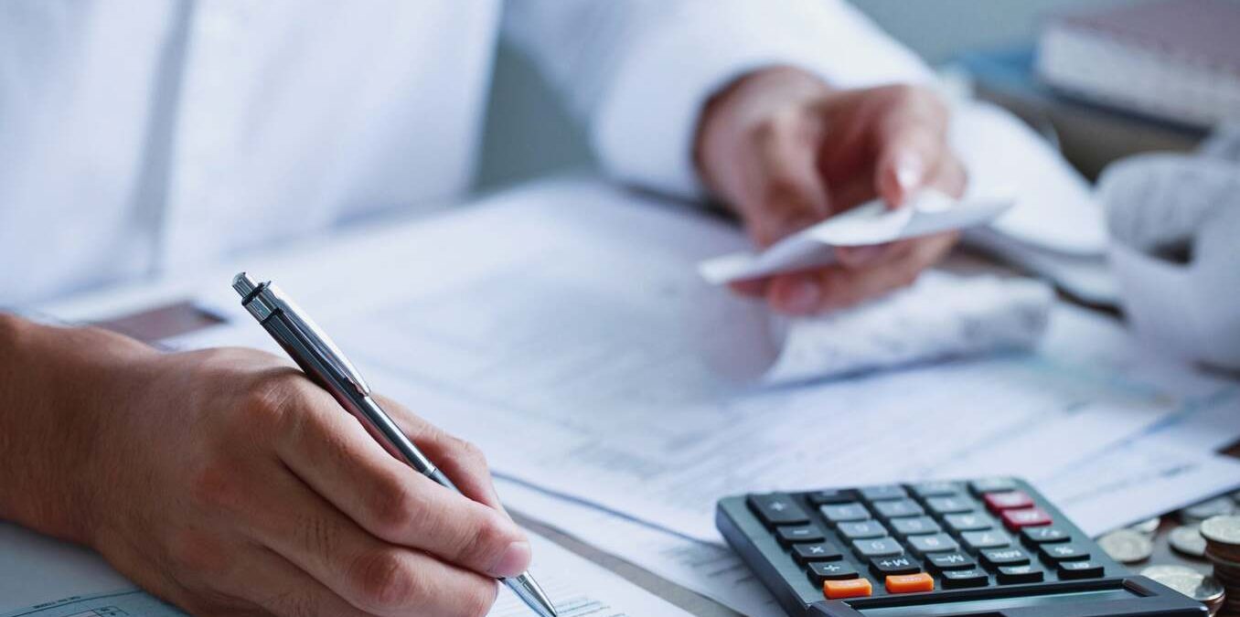 Man hand filling US tax form. tax form us business income office Financial document. Tax time.Tax concept. Close-up