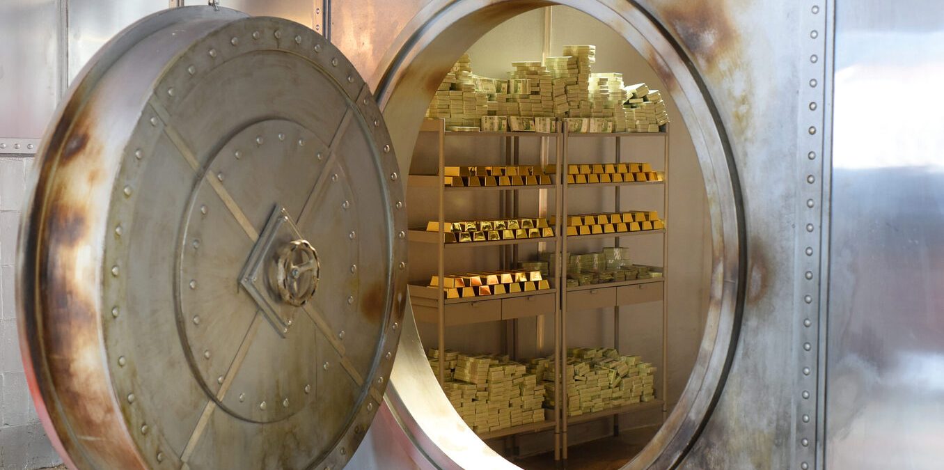 An open safe with gold and banknotes