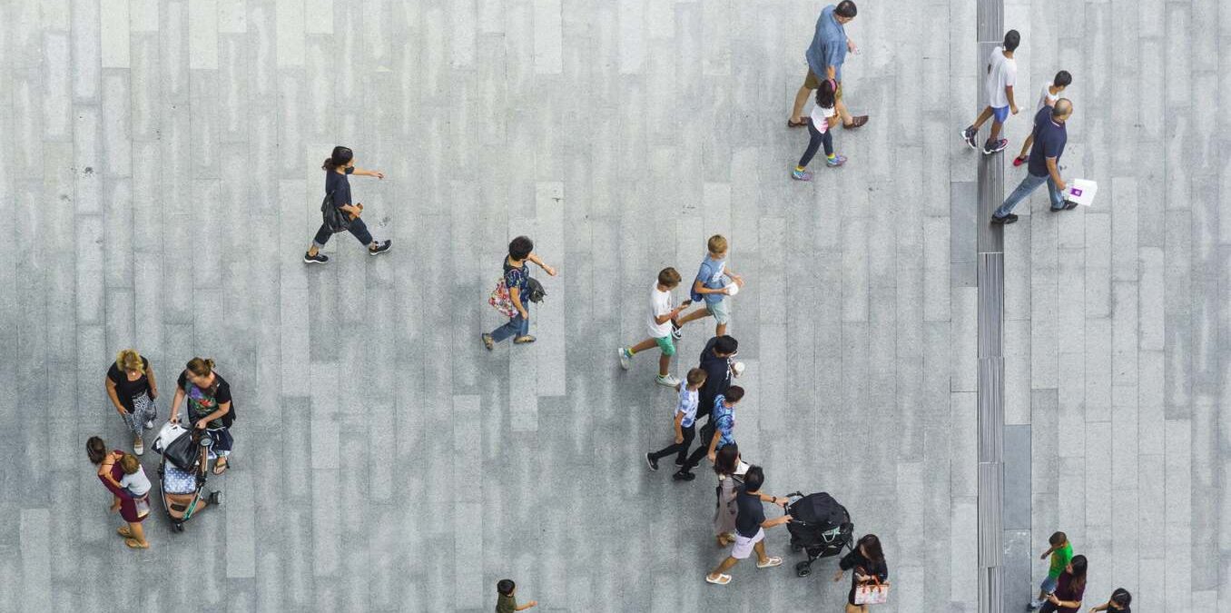 people walk on the pedestrian street walkway with the teenage young man and the group of family with little child. (Aerial urban city photo)