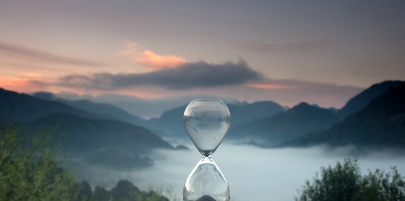 A,Hourglass,(with,Falling,Sand),On,A,Wooden,Wet,Table