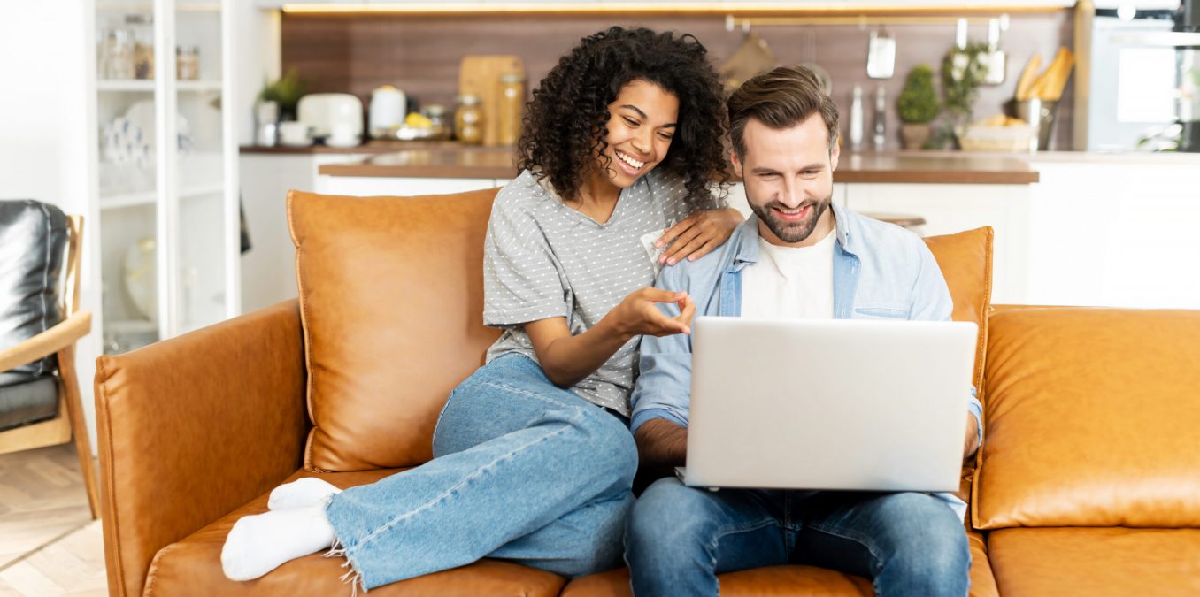 Cheerful,Diverse,Couple,In,Love,Spends,Leisure,Time,Online,With