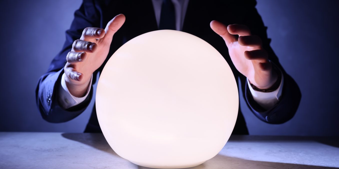Businessman,Using,Glowing,Crystal,Ball,To,Predict,Future,At,Table,