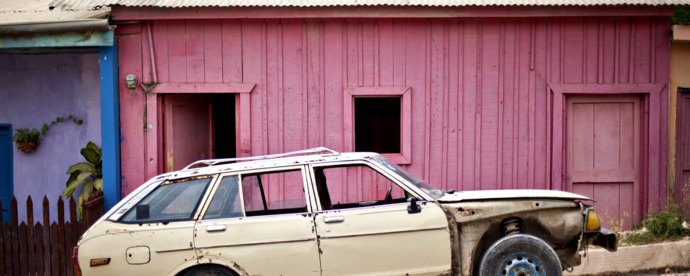 Old,Car,In,Front,Of,Pink,Building