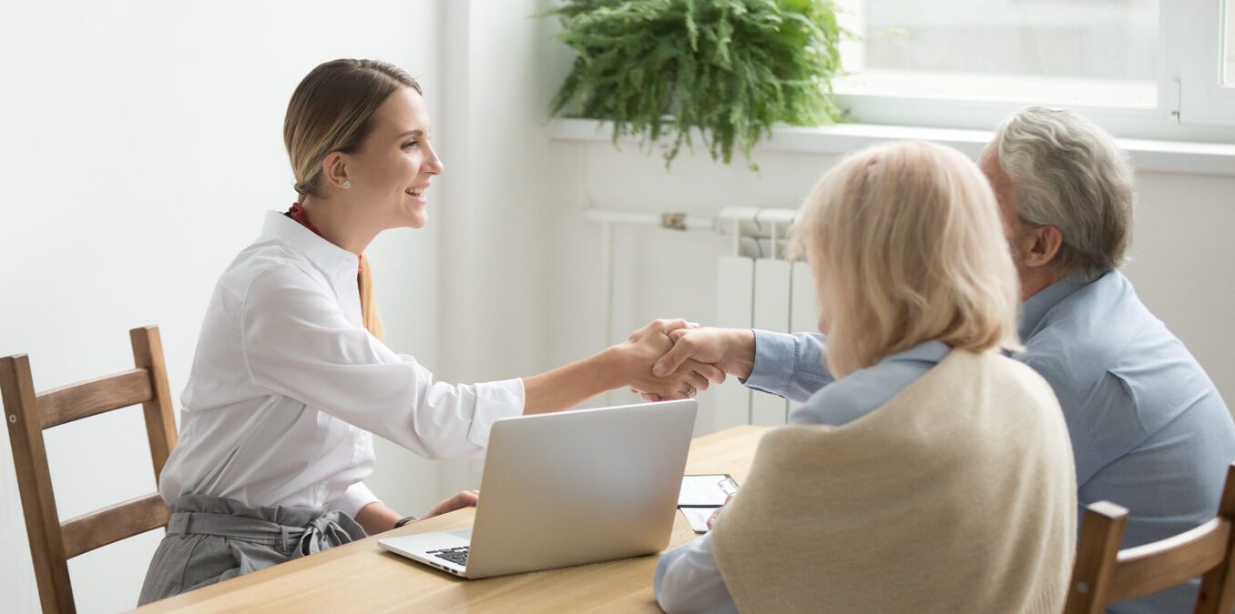 Smiling female lawyer real estate agent or financial advisor handshaking