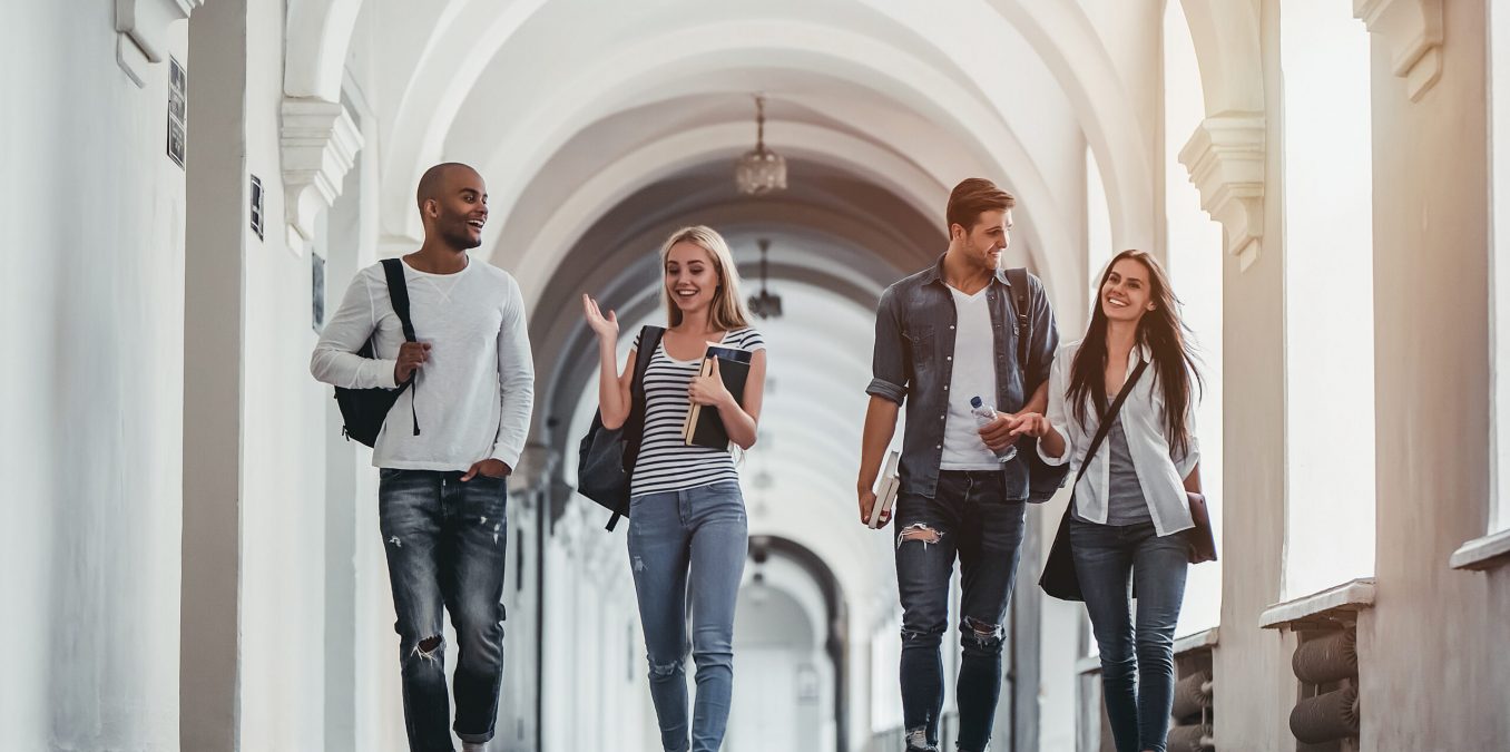 Multiracial,Students,Are,Walking,In,University,Hall,During,Break,And