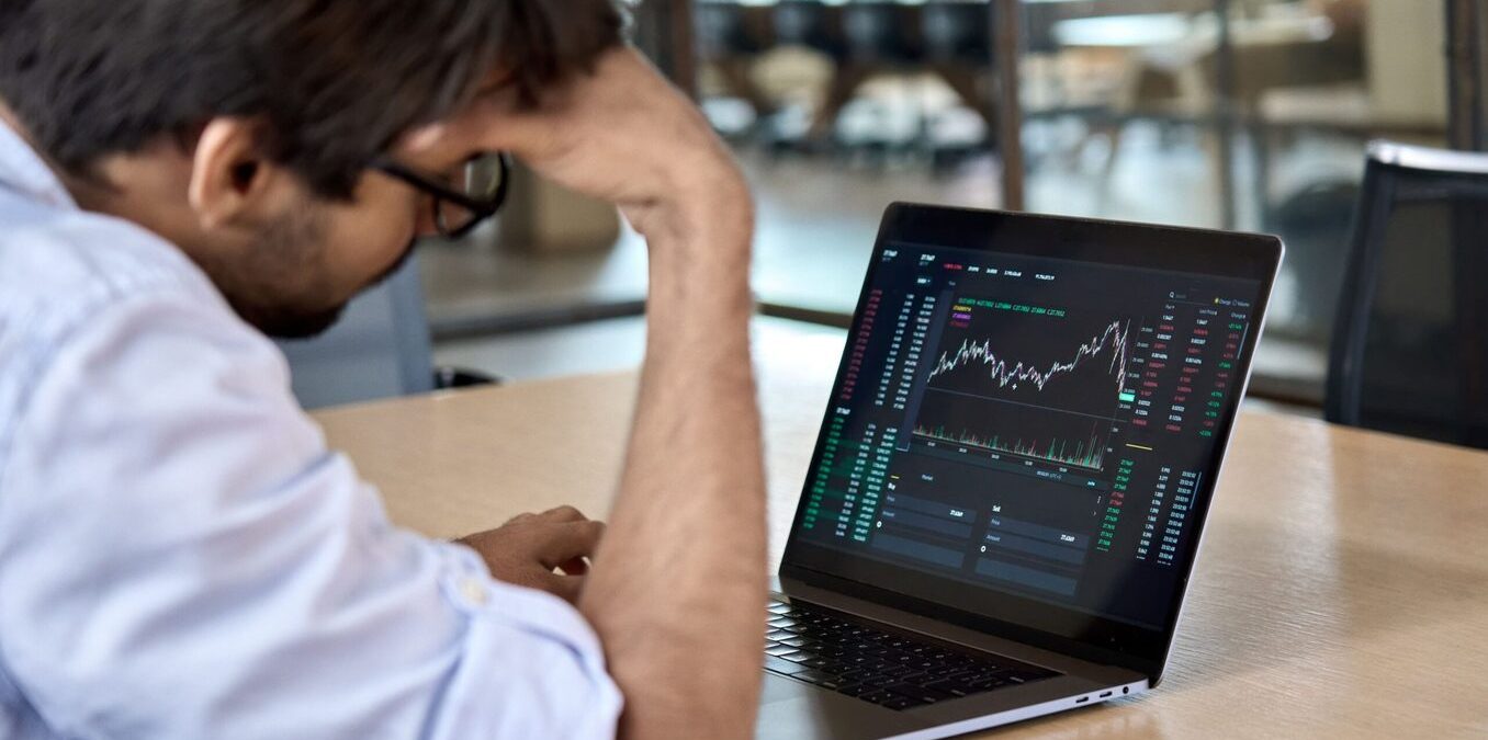Stressed business man crypto trader broker investor analyzing stock exchange market crypto trading decreasing chart data fall down loss, desperate about losing money of crisis, recession, inflation.