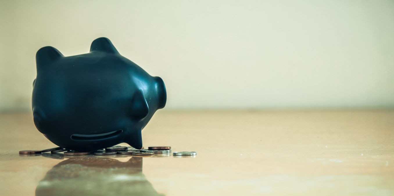 Piggy,Bank,Upside,Down,And,Coins.,Financial,Crisis,Concept.